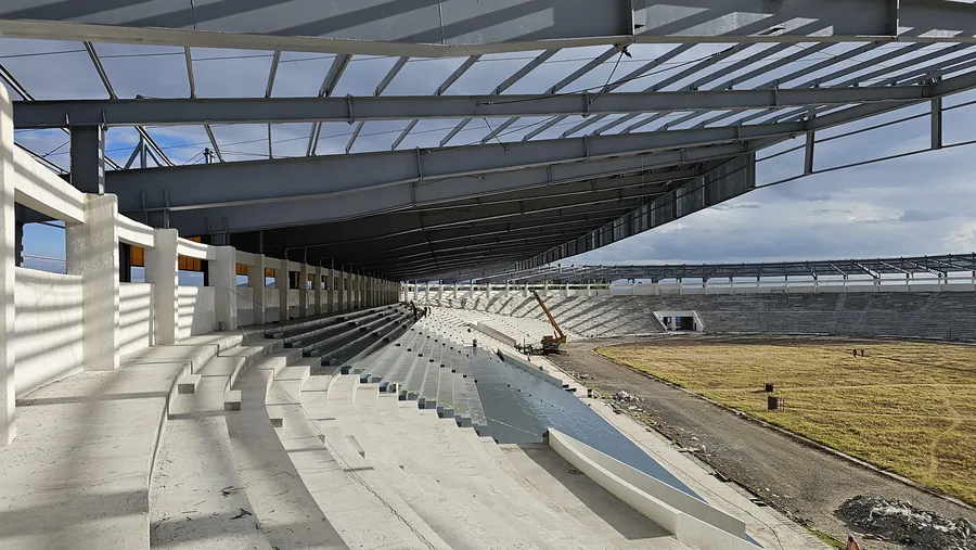 Large institutional stadium structure with steel roof